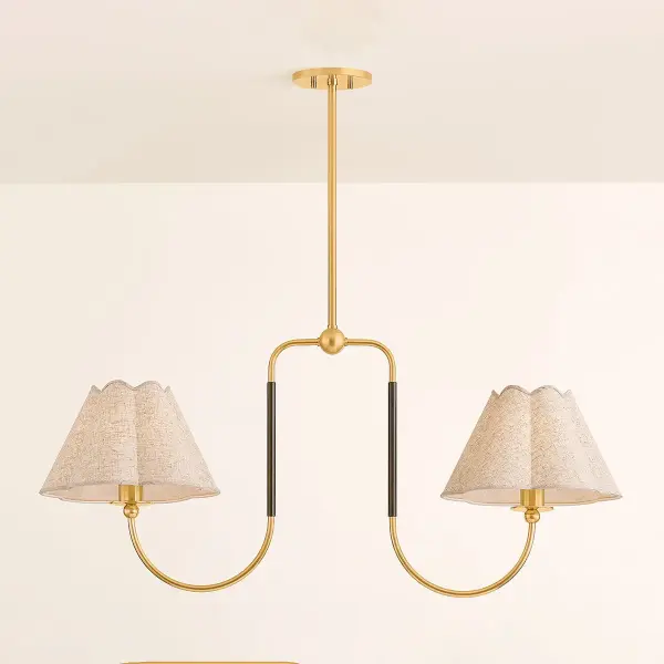 The Janie Linear updates classic chandelier design with a fresh, contemporary silhouette. Scalloped glass shades provide softly diffused lighting while the contrasting Aged Brass and True Bronze finishes create visual interest and versatility. - alternate view