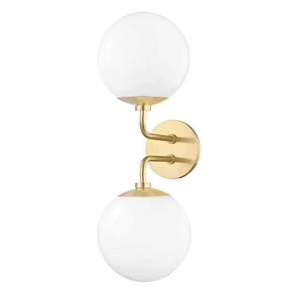 The Stella Wall Sconce brings fresh mid-century modern style with its sleek frosted glass globe and aged brass finish. Versatile enough for any room, this fixture combines clean lines with warm illumination.