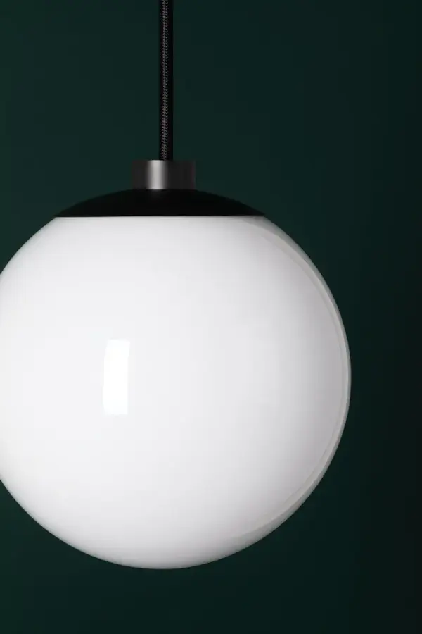 The Stella Pendant brings classic mid-century modern style to any space with its frosted glass globe and sleek bronze finish. Versatile enough for kitchens, dining rooms, or bedrooms, this fixture offers clean lines and soft illumination. - alternate view