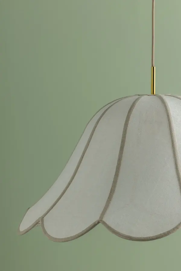 The Dara pendant brings soft, organic elegance with its pillowy scalloped design that mimics flower petals. White linen with natural trim creates dynamic light diffusion while Aged Brass accents add luxe warmth. - alternate view