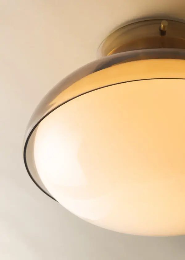 The Gianna combines organic curves with mechanical precision through its distinctive double-glass design. Light bronze outer glass melts into glossy opal inner shade, held by industrial-style pins for a refined contemporary look. - alternate view