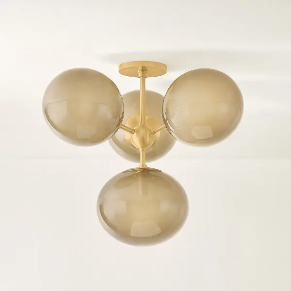 The Zaley Semi Flush brings mid-century modern flair with its Sputnik-inspired silhouette. Irregular light bronze glass globes radiate from an aged brass sphere, creating a moody, artistic focal point perfect for contemporary spaces. - alternate view