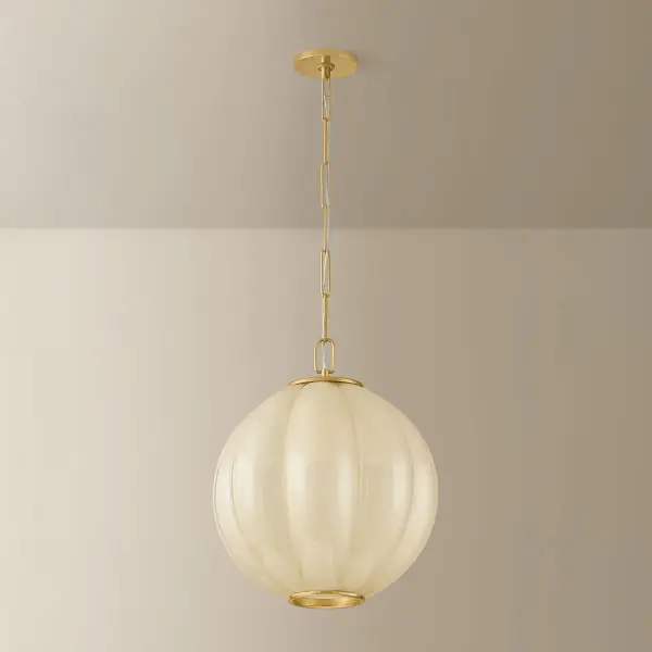 The Bernadine pendant elevates the popular scalloped trend with its grand-scale clear etched cream glass shade and pillowy contours. Aged Brass frame details bookend the shade like jewelry, creating a versatile statement piece. - alternate view
