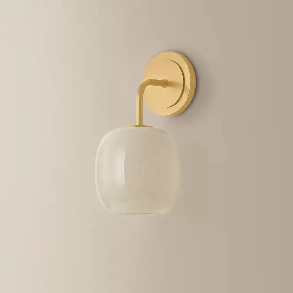 The Lisette Wall Sconce brings refined botanical elegance to any space with its fluted cream opal glass shade and warm Aged Brass finish. Its nuanced geometric design adds sophisticated visual interest while providing soft, diffused lighting. - alternate view