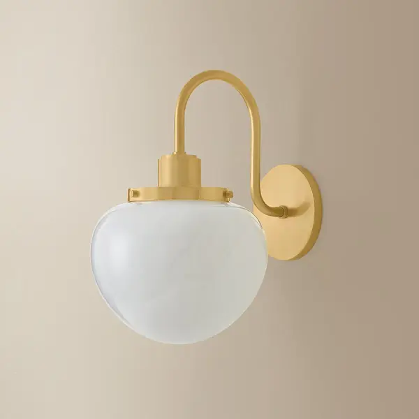 The Kristen Wall Sconce reimagines Art Deco elegance with playful proportions and distinctive Cloud Glass. Its Aged Brass finish adds warmth and character, making it perfect for creating soft, glamorous ambiance in intimate spaces. - alternate view