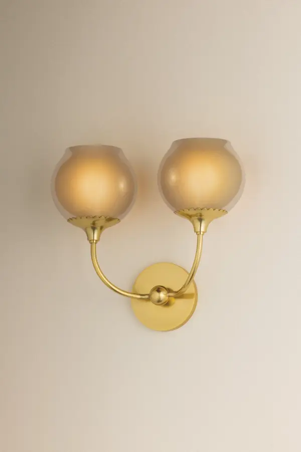 The Daya Wall Sconce combines organic elegance with refined craftsmanship. Its champagne-tinted opalescent glass orbs create a serene, glowing ambiance, while the Aged Brass finish and scalloped fitter add botanical charm. - alternate view