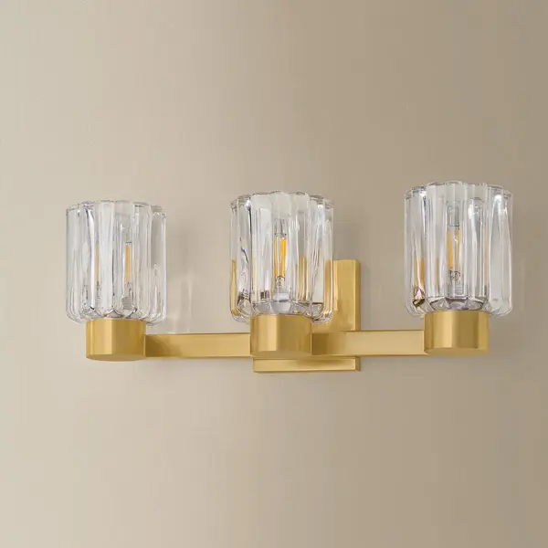 The Danae Bath Sconce brings sophisticated European design to your bathroom with its distinctive fluted glass shade inspired by Orrefors vases. The scalloped glass beautifully diffuses light while the clean metalwork adds refined elegance. - alternate view