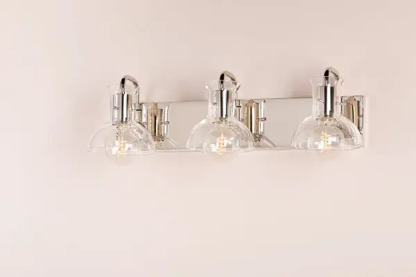 The Riley Bath and Vanity Light combines classic elegance with contemporary styling. Its polished nickel finish and clean lines make it versatile for various bathroom designs, from traditional to modern aesthetics. - alternate view