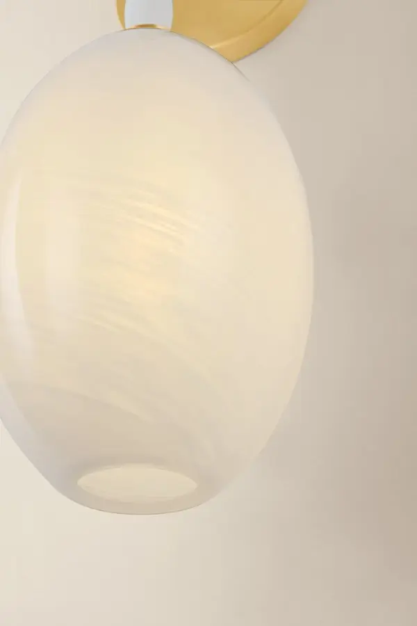 The Yolanda Wall Sconce transforms any wall into a statement piece with its delicate etched glass shade suspended from a strand of natural alabaster beads. The cloud-etched glass creates a soft, milky glow while the Aged Brass finish adds timeless sophistication. - alternate view