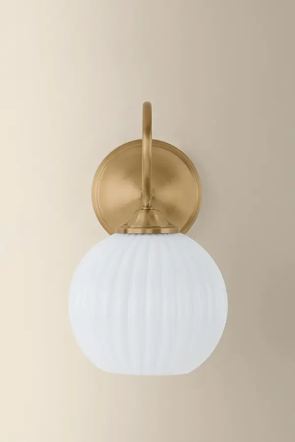The Vida Wall Sconce combines vintage charm with modern functionality. Its slender gooseneck arm in Patina Brass finish and scalloped opal glass shade create a balanced, graceful look perfect for smaller spaces. - alternate view