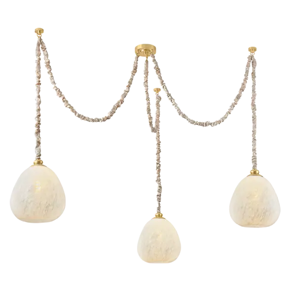 Imbued with a sense of Parisian romance, the Remi family's use of textiles and artisanal glasswork is nothing short of ethereal. A white silk sleeve gathers over the suspension chain, supporting a clear cloud glass globe that floats in space like a drop of rain. The single-light pendant format serves as a delicate focal point, while the three-light swagged chandelier emits illumination to fill an entire room. Accents of Aged Brass unite each element of Remi. Part of our Hilary Matt x Mitzi Tastemakers collection. Collection: Remi Designer: Hilary Matt Finish: Aged Brass Glass: Clear Cloud Width: 67.50" Height: 16.25" Weight: 18.11 lb Chain: 72" Canopy: 5.00"x1.00" Number of Bulbs: 3 Maximum Wattage: 15.00 W Bulb Type: G25 Bulb Base: E26 Medium Voltage: 120.00 V Material: Steel Country of Origin: VN Safety Listing: UL/cUL Safety Rating: Damp Manufacturer Warranty: 1 Year Limited Manufacturer Spec Sheet Instructions