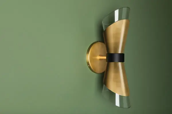 The Angie Wall Sconce brings high-fashion flair to your walls with its distinctive cinched-waist glass shade wrapped in metal. This style chameleon works beautifully in aged brass for warmth or polished nickel for cool sophistication. - alternate view