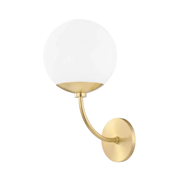 The Carrie Wall Sconce combines classic elegance with contemporary simplicity. Its aged gold brass finish and glass globe shade create a sophisticated lighting solution perfect for bathrooms, hallways, and bedrooms.