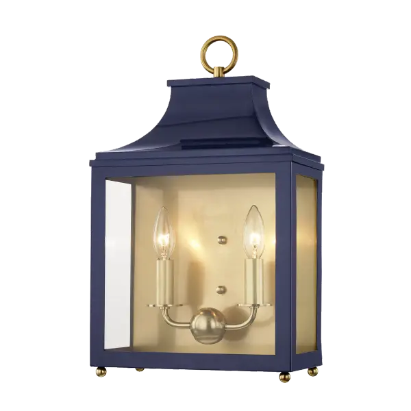 The Leigh Wall Sconce combines aged gold brass metalwork with a refined navy fabric shade, creating a sophisticated lighting solution perfect for residential and hospitality settings.