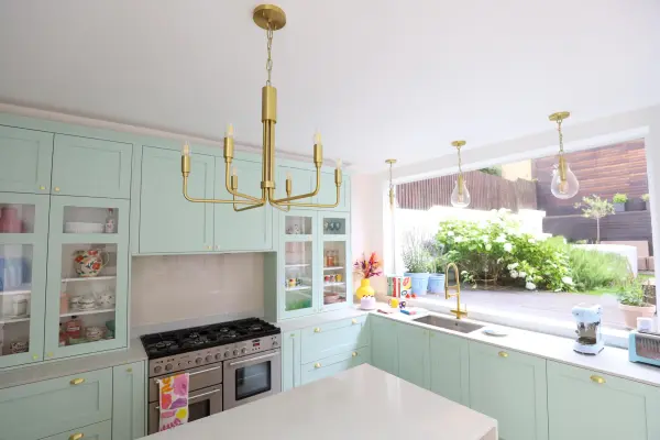 The Brigitte Chandelier combines classic elegance with contemporary sensibility. Its aged gold brass finish and glass globe shades create sophisticated ambient lighting perfect for dining rooms and entryways. - alternate view