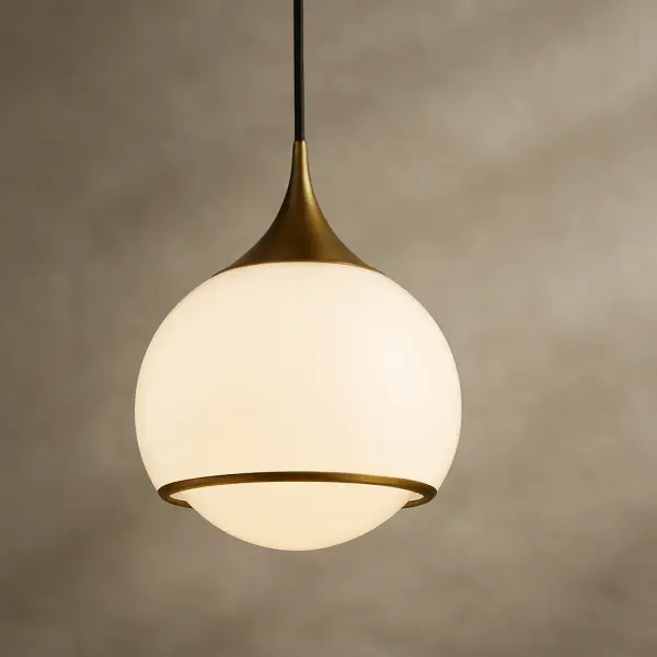 The Reese Pendant combines classic elegance with contemporary sensibility, featuring an aged gold brass finish that adds warmth to any space. Its versatile design works beautifully over kitchen islands, dining tables, or in entryways. - alternate view