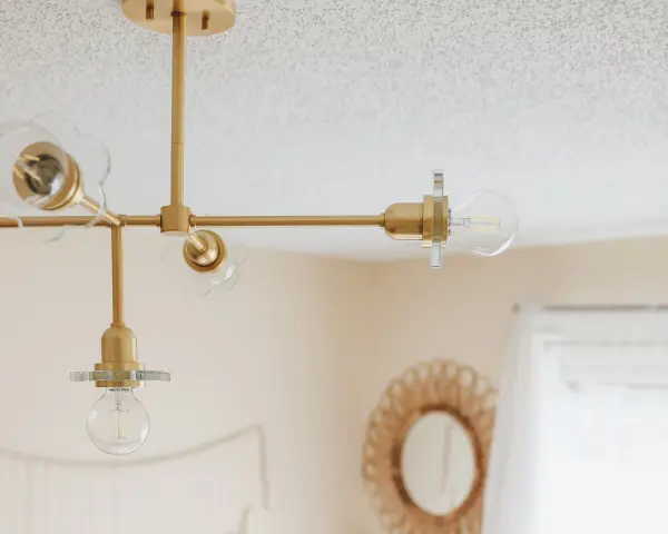 The Alexa Chandelier combines classic elegance with contemporary sensibility, featuring an aged brass finish and glass globe shades. Perfect for adding sophisticated lighting to dining rooms and entryways. - alternate view
