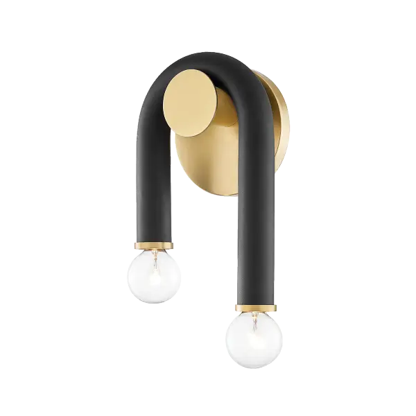 The Whit Wall Sconce brings whimsical charm to modern lighting with its distinctive sweeping black metal tube draped over aged brass accents. The uneven lines create visual interest while providing flexible uplight or downlight options.