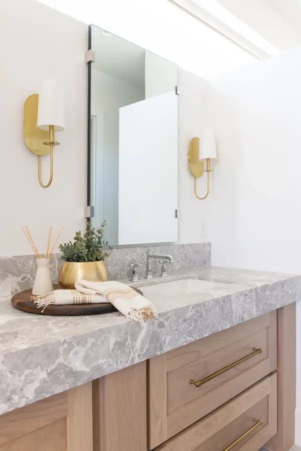 The Lara Wall Sconce combines classic design with contemporary sensibility, featuring an aged brass finish and glass globe shade. Perfect for adding sophisticated ambient lighting to bathrooms, hallways, and bedrooms. - alternate view