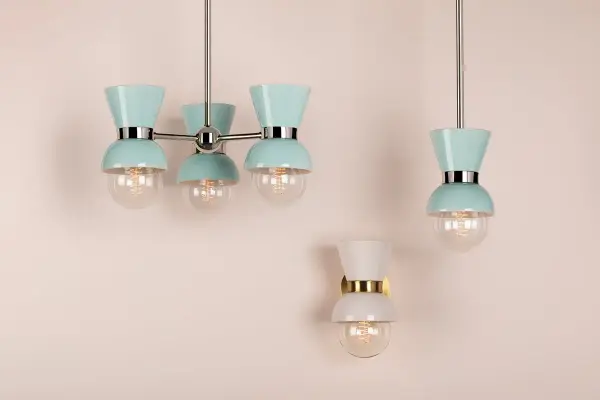 The Gillian Wall Sconce combines youthful charm with sophisticated design through expertly-crafted ceramic shades in milky cream tones. Aged brass metal accents add warmth, making this fixture versatile for modern interiors. - alternate view