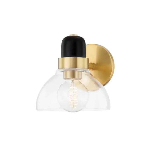 The Camile vanity light blends industrial charm with contemporary elegance. Its open, exaggerated shade and hand-blown glass create natural mystique, while the two-tone aged brass and black finish adds sophisticated contrast.