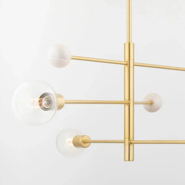 The Slater Chandelier makes a bold architectural statement with its exaggerated 4-foot vertical scale and ultra-slim profile. Whitewashed ash wood beads create organic texture against the warm aged brass finish, perfect for modern spaces seeking natural elements. - alternate view