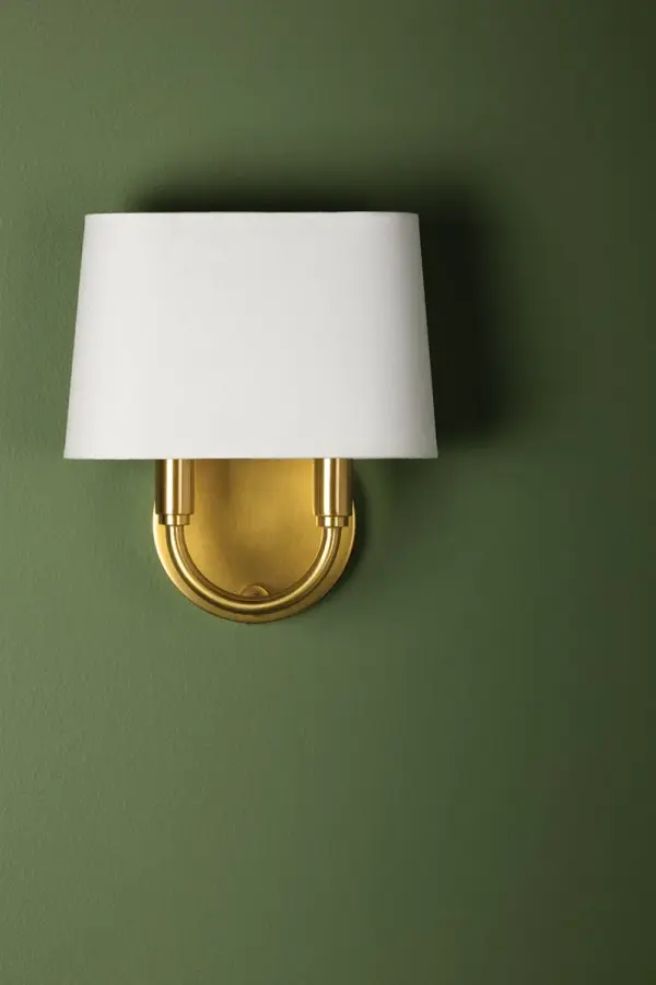 The Clair Wall Sconce combines sleek curves with a sophisticated tapered linen shade, delivering understated elegance. Perfect for flanking fireplaces or illuminating powder rooms with refined style. - alternate view