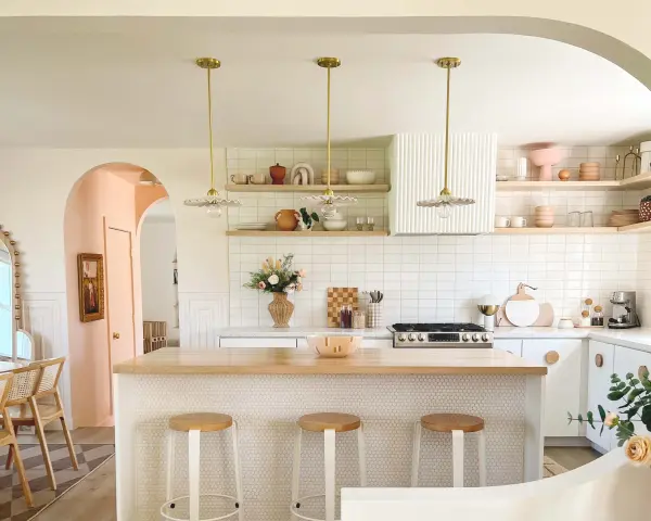 The Tinsley Pendant combines southern charm with whimsical design through its distinctive white ceramic collar and aged brass finish. Perfect for adding character above kitchen islands or bars, this fixture pairs vintage appeal with modern sensibility. - alternate view