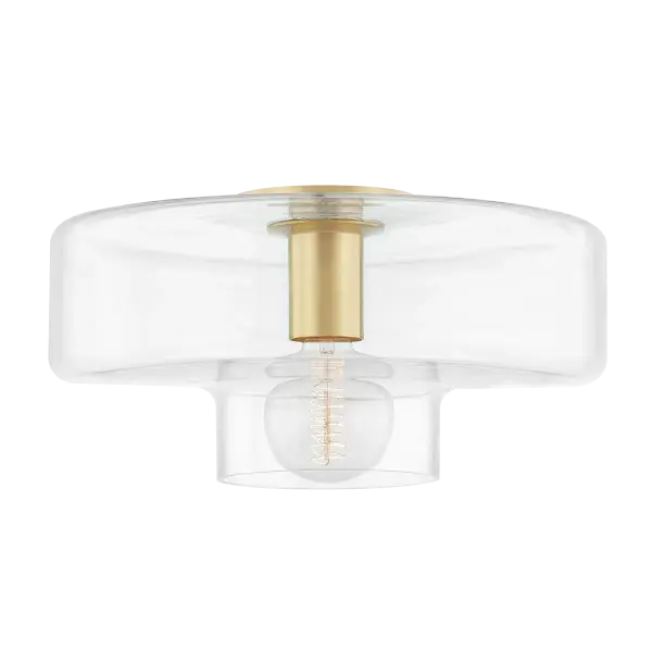 The Iona Flush Mount reimagines the traditional mushroom fixture with contemporary flair. Its clear glass drum shade beautifully showcases the globe bulb while the aged brass finish adds warmth and sophistication to any space. - alternate view