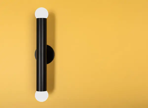 The Taylor Wall Sconce transforms hand-cut crystal into a stunning light sculpture. Its faceted design creates brilliant prismatic effects while the satin black finish adds contemporary edge to both lavish and understated interiors. - alternate view