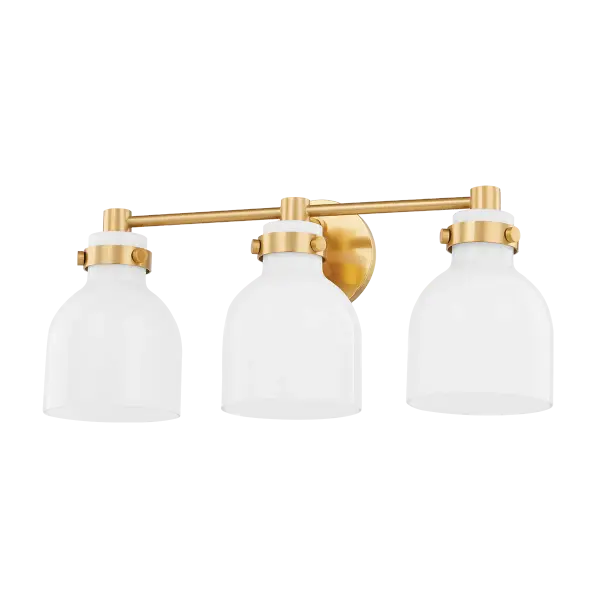 The Elli Bath and Vanity combines vintage charm with modern functionality. Bell-shaped opal glass shades provide soft, flattering light while aged brass hardware adds warmth and sophistication to any bathroom.