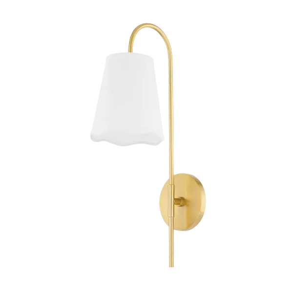 The Dorothy Wall Sconce masterfully combines traditional craftsmanship with contemporary design. Its aged brass stem and crisp linen shade with distinctive wavy edge create a striking focal point that elevates any space.