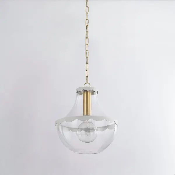 The Alaina Large Pendant combines timeless elegance with soft, feminine details. Its bell-shaped silhouette features delicate cream scalloped trim that adds visual interest, while aged brass accents provide warmth and subtle sophistication. - alternate view