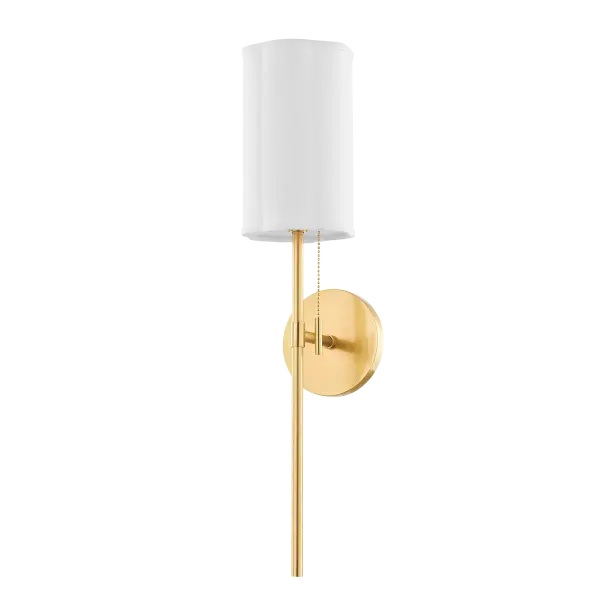 The Fawn Wall Sconce combines sleek sophistication with subtle feminine touches. Its scalloped fabric shade and aged brass pull chain create a refined look that works beautifully in traditional and contemporary spaces alike.