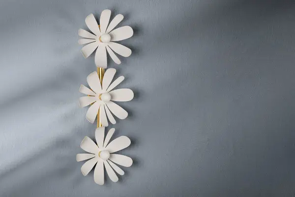Twiggy brings botanical beauty to bathroom lighting with textured white petals radiating from an opal matte center. The aged brass accents provide subtle warmth while maintaining the fixture's organic aesthetic. - alternate view