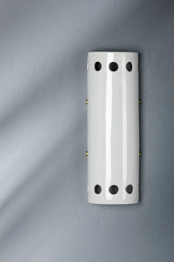 The Jean Wall Sconce combines classic aged brass finish with clear glass for a sophisticated lighting solution. Its compact design and transitional style make it versatile for various interior settings. - alternate view