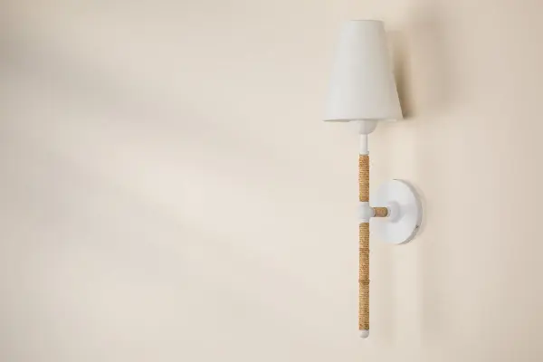The Mariana Wall Sconce features handcrafted textured glass that creates unique light patterns and visual interest. Each piece is one-of-a-kind with natural variations in color and pattern, making it perfect for adding artisanal character to contemporary spaces. - alternate view