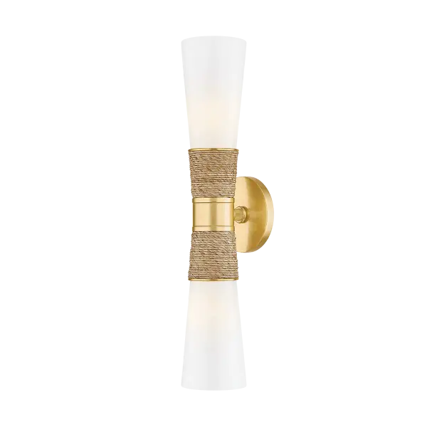 The Mica Wall Sconce beautifully blends coastal charm with quiet luxury through its wrapped raffia detail and sleek aged gold brass finish. Perfect for creating ambient lighting in powder rooms and kitchens, this designer fixture adds an approachable yet sophisticated touch to any space.