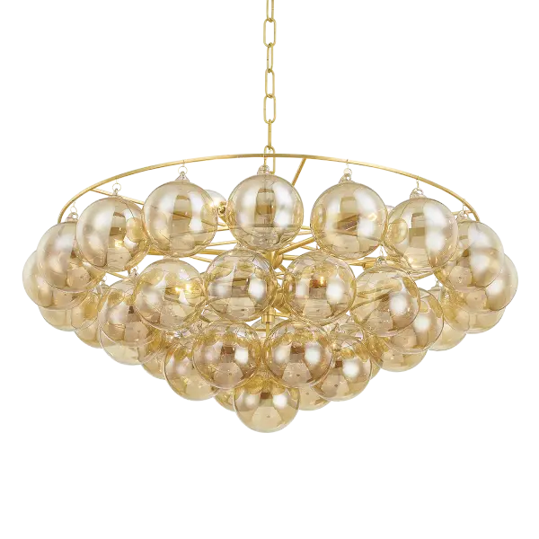 The Mimi Chandelier features swirl-ribbed champagne glass globes suspended from an Aged Brass frame, creating a sophisticated cloud-like effect. Part of the Megan Molten x Mitzi collaboration, this showstopper brings glamorous style to dining rooms, entryways, and breakfast nooks.