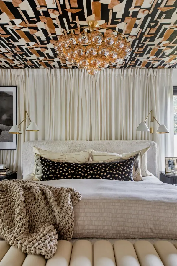 The Mimi Chandelier features swirl-ribbed champagne glass globes suspended from an Aged Brass frame, creating a sophisticated cloud-like effect. Part of the Megan Molten x Mitzi collaboration, this showstopper brings glamorous style to dining rooms, entryways, and breakfast nooks. - alternate view