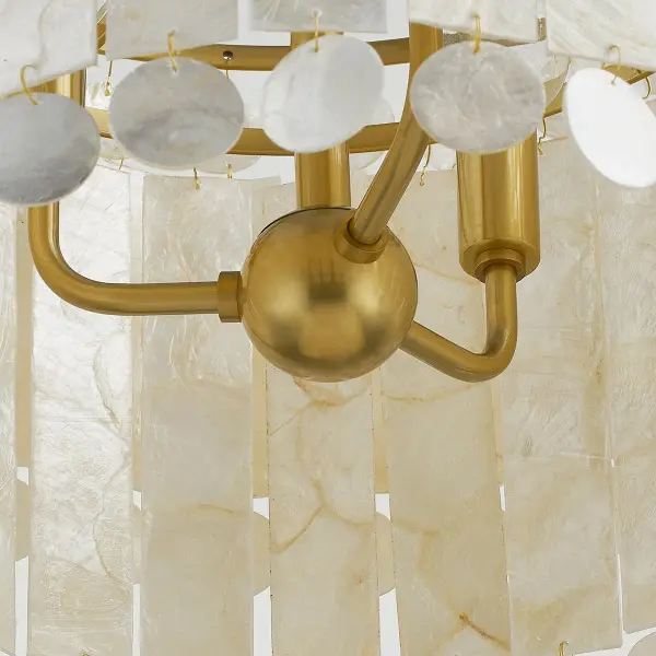 The Melisa Pendant brings coastal sophistication to any space with gorgeous layers of Capiz shell in alternating circles and rectangles. The Aged Brass frame adds warmth while the natural shell creates beautiful light diffusion and organic texture. - alternate view