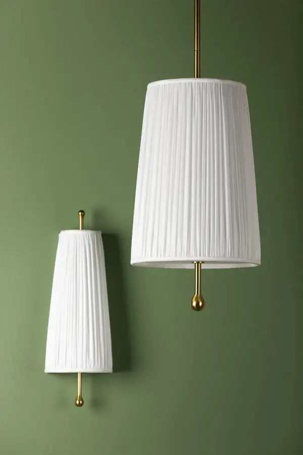 The Adeline Wall Sconce combines feminine elegance with transitional versatility. Its pleated white fabric shade and aged brass stem create a sophisticated look perfect for bedrooms, bathrooms, and hallways. - alternate view