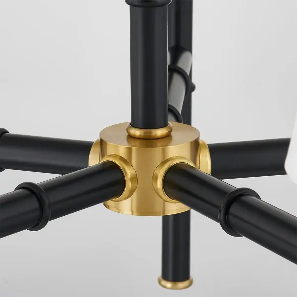 The Banyan Chandelier features an abstracted bamboo design inspired by Henry Link Bali Hai furniture, offering organic style with sophisticated metalwork. The aged gold brass and soft black finish combination provides versatility. - alternate view