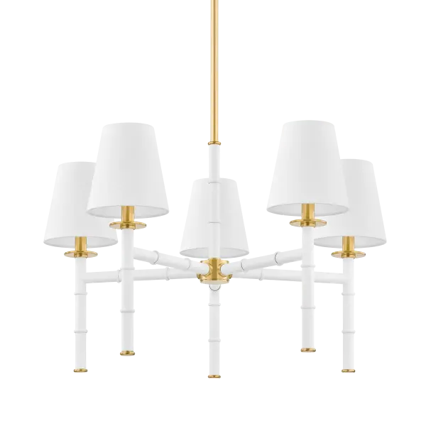 The Banyan Chandelier features an abstracted bamboo design that adds organic, coastal-inspired style to dining rooms and living spaces. Part of the Ariel Okin collaboration, it combines aged gold brass with soft white accents for a sophisticated yet natural aesthetic.
