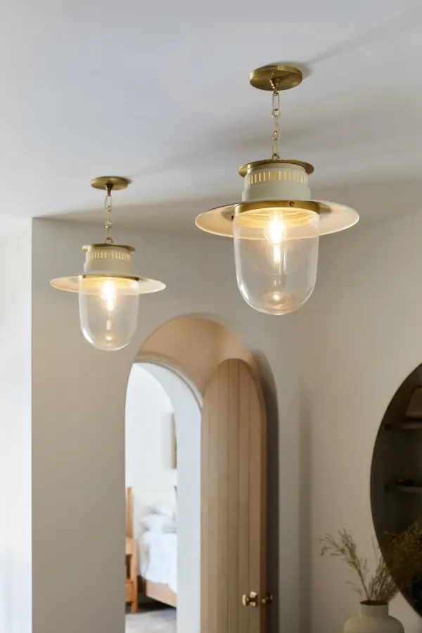 The Nori Pendant masterfully bridges traditional lantern styling with contemporary refinement. Its aged brass finish and intricate link chain evoke vintage appeal, while sleek perforations and clean lines keep it fresh and modern. - alternate view