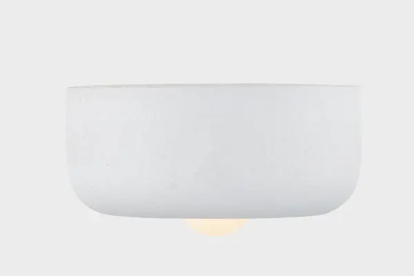 The Doris Flush Mount combines tactile ceramic craftsmanship with modern minimalism. Its cloud-like form and partially exposed bulb create an inviting glow while maintaining a low profile perfect for intimate spaces. - alternate view