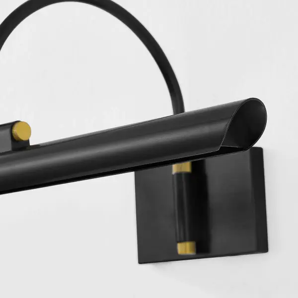 The Elowen Picture Light combines timeless picture light design with integrated LED technology. Its slender silhouette and arched neck support a folded tubular shade that creates a focused band of illumination perfect for artwork. - alternate view