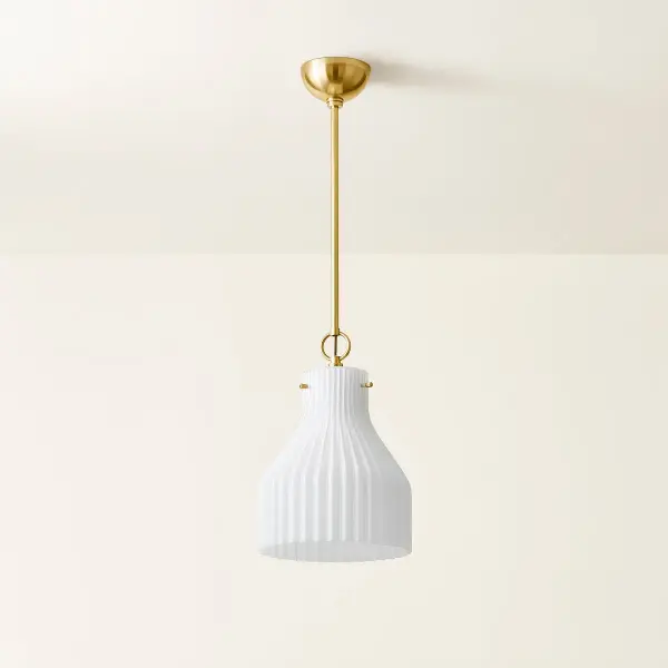 The Corinthia Pendant brings sophisticated simplicity to any space with its gracefully ribbed opal glass shade and aged brass finish. Perfect for solo installation or grouped arrangements above countertops and hallways. - alternate view