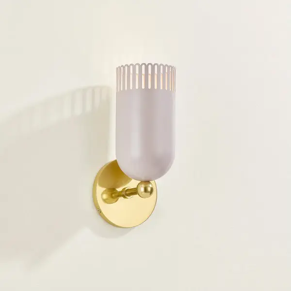 Zoe Feldman's Liba sconce combines timeless form with whimsical details. The warm neutral shade with pink undertones creates an inviting glow, while slender scalloped edges add visual interest. Aged Brass framework provides sophisticated contrast. - alternate view