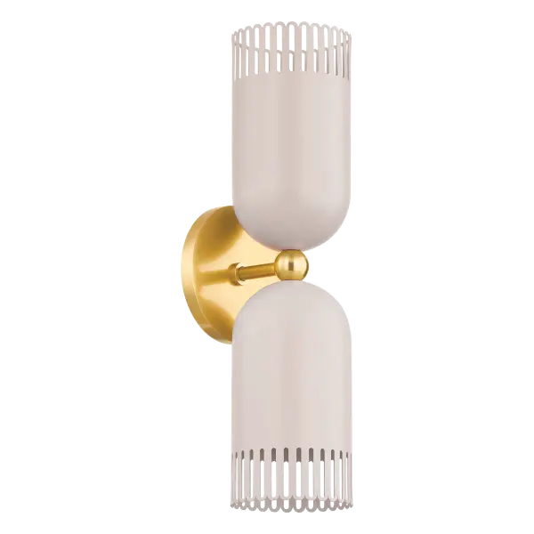 Zoe Feldman's Liba brings sophisticated whimsy to wall lighting with its unique warm neutral shade featuring a subtle pink hue and scalloped edges. The Aged Brass framework adds timeless elegance while the playful design creates an inviting atmosphere.